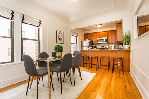 a dining room and kitchen with a table and chairs