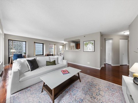 A living room with a white couch and a coffee table.