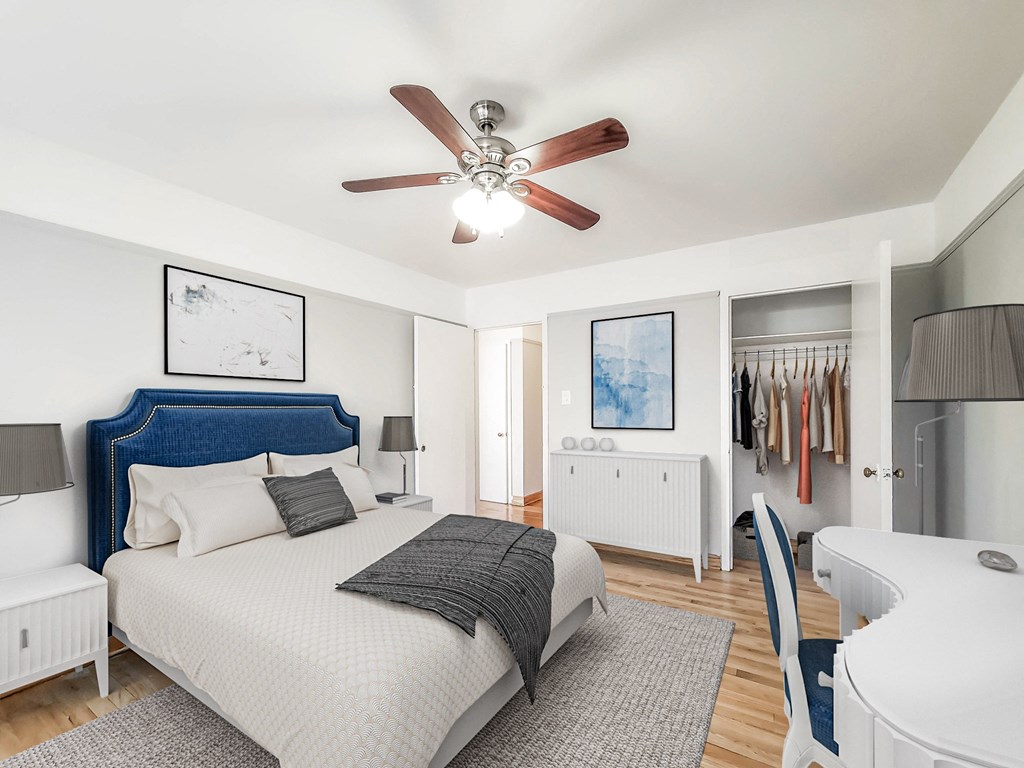 a bedroom with a bed and a ceiling fan