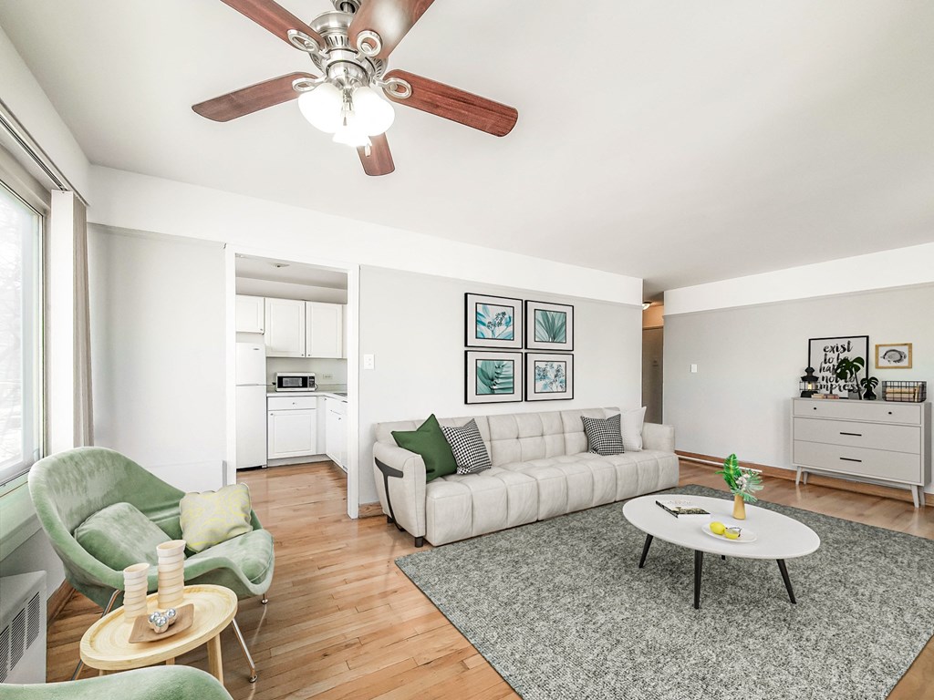 a living room with a white couch and a green chair