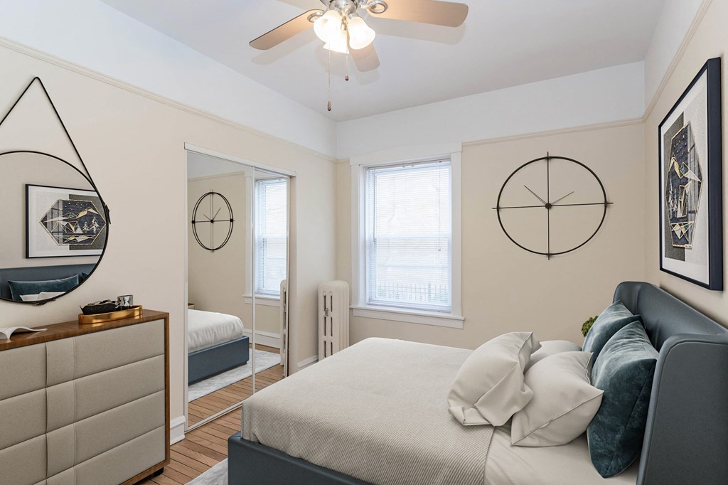a bedroom with a bed and a ceiling fan