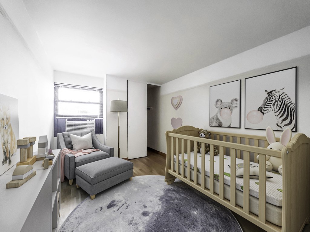 a bedroom with a crib and a couch in a 555 waverly unit
