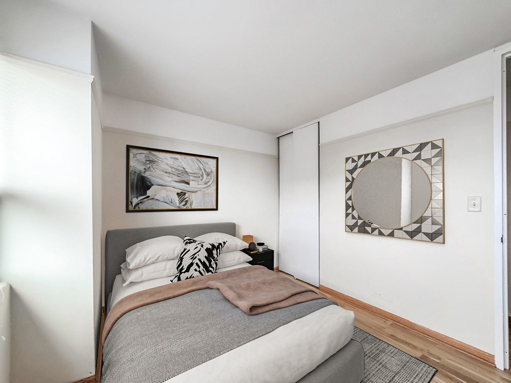 a bedroom with a large bed and a mirror on the wall