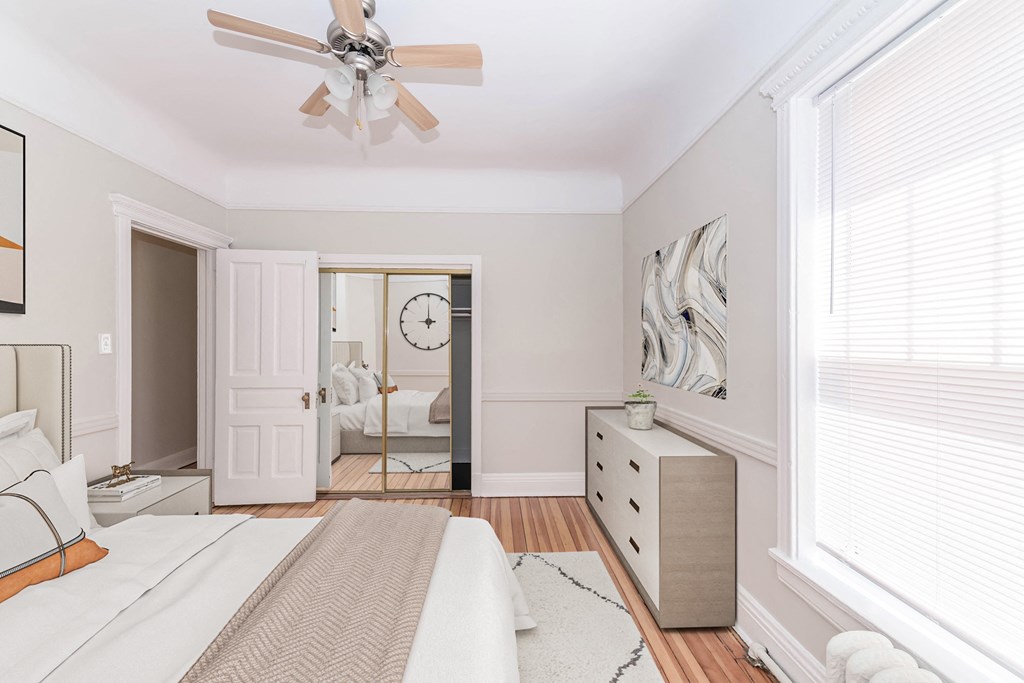 a bedroom with a bed and a ceiling fan