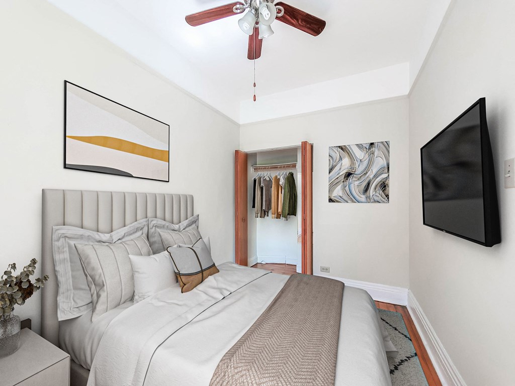 a bedroom with a large bed and a ceiling fan
