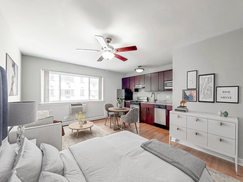 a bedroom with a large bed and a ceiling fan