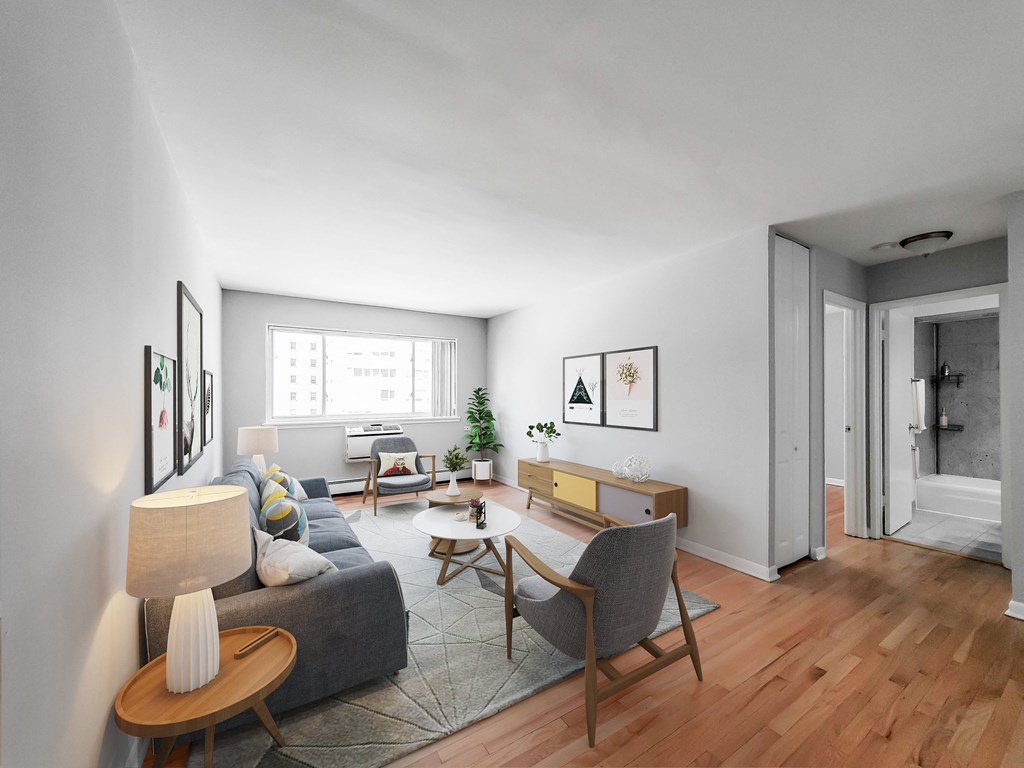 a living room with white walls and hardwood floors