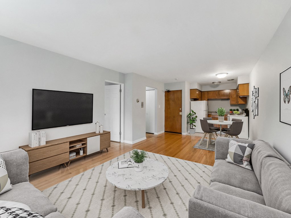 a living room with a large tv on the wall and a couch in front of a table