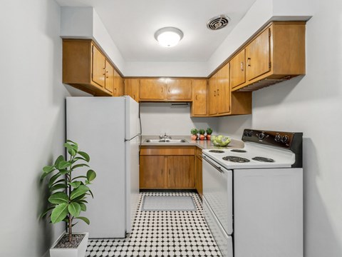 a kitchen with white appliances and wooden cabinets