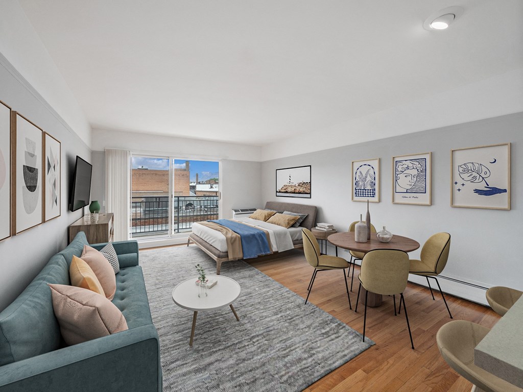 a bedroom with a bed and a table with chairs in a room with a couch and a