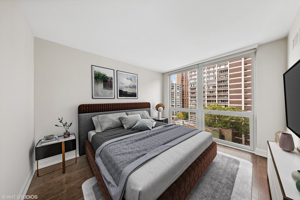a bedroom with a large bed and a large window