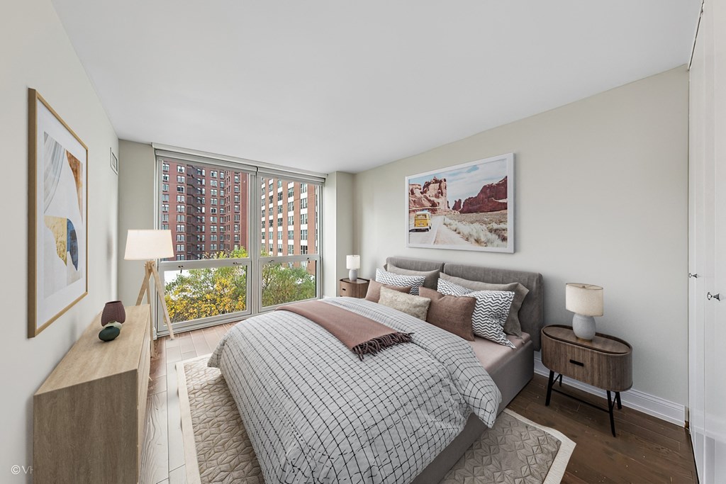 a bedroom with a bed and a large window