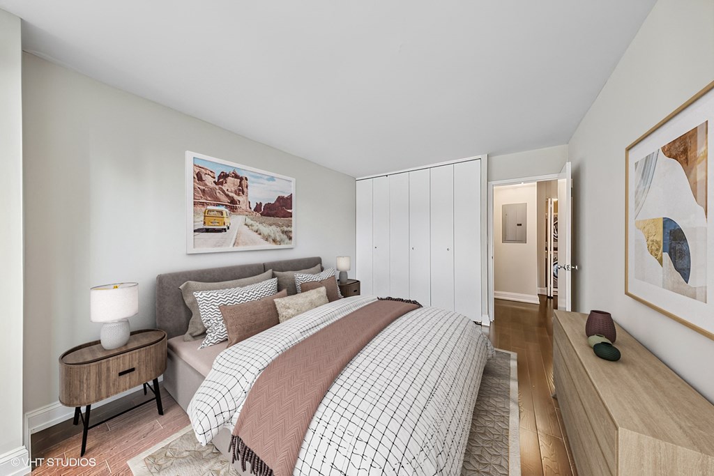 a bedroom with white walls and a bed with pillows
