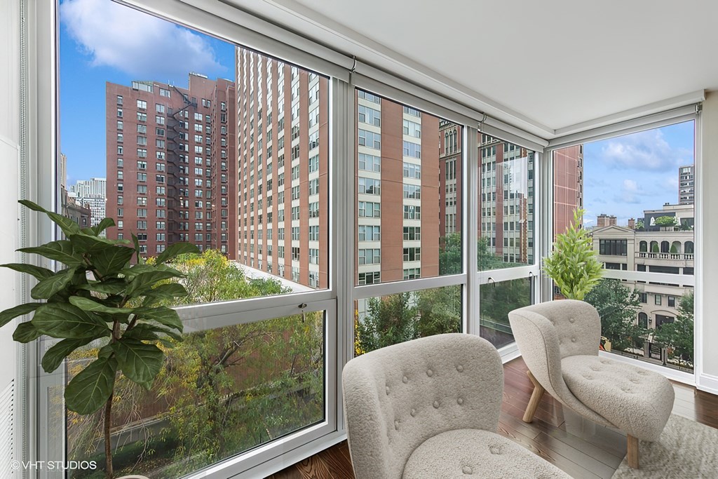 a living room with large windows and a view of the city