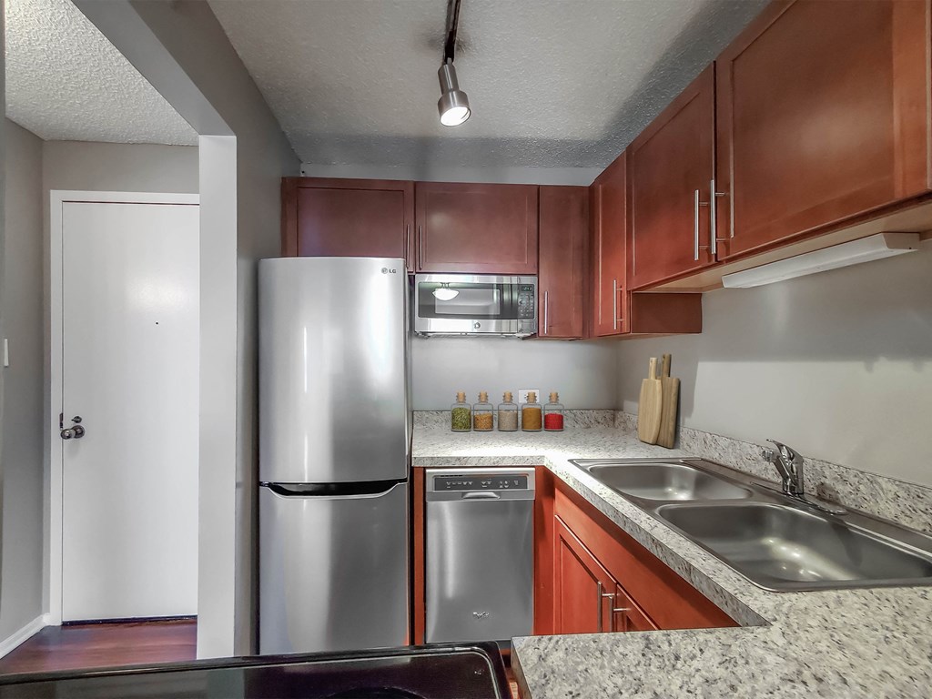 a kitchen with stainless steel appliances and wooden cabinets