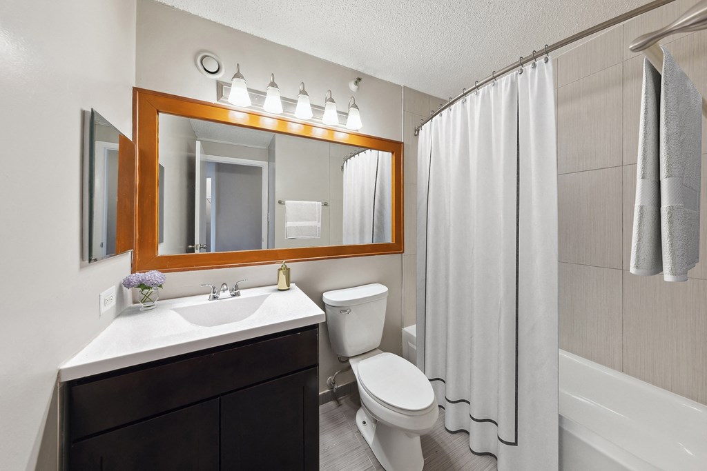 the preserve at ballantyne commons apartment bathroom with toilet sink and shower