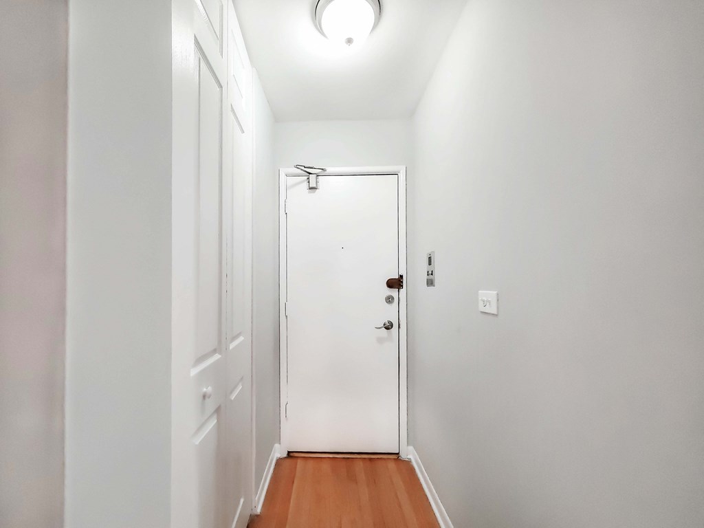 a bedroom with a medium sized bed and a white door