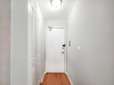 a bedroom with a medium sized bed and a white door