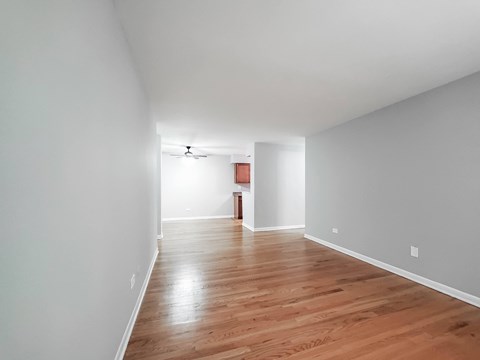 a bedroom with gray walls and a hardwood floor
