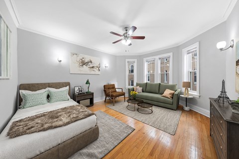 Bright studio at Green Manor with bed, sofa, bay windows and hardwood floors, Apartments in Ravenswood Chicago.