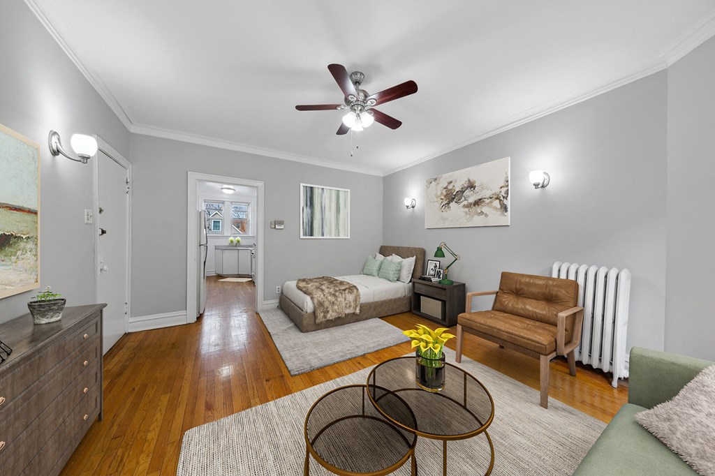 a living room with a couch and a ceiling fan