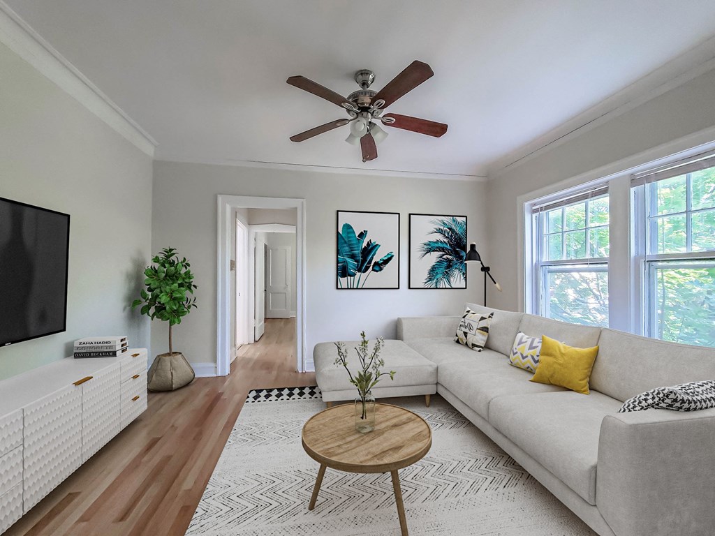 a living room with a couch and a ceiling fan