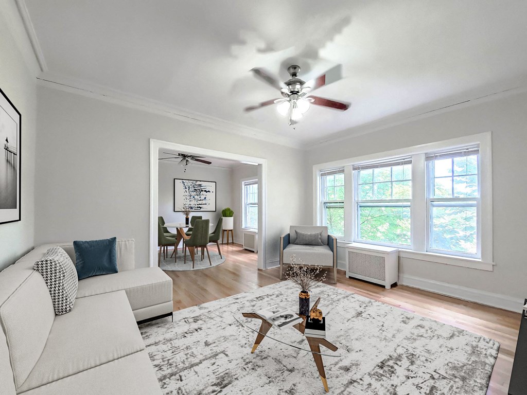 a living room with a couch and a ceiling fan