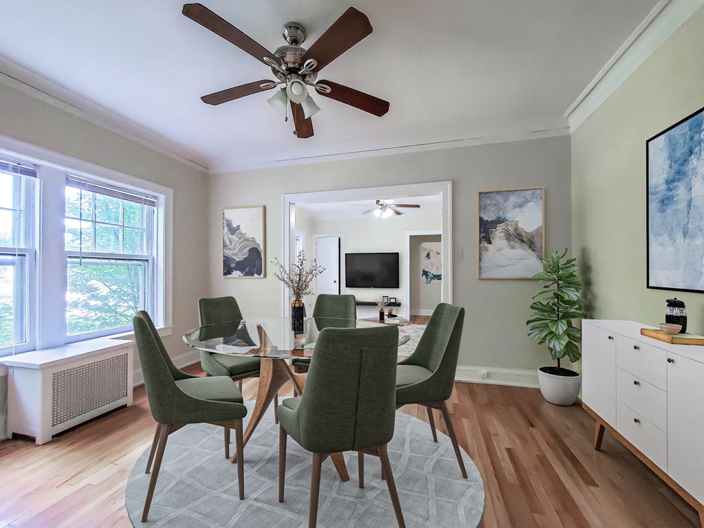 a dining room with a table and chairs and a ceiling fan
