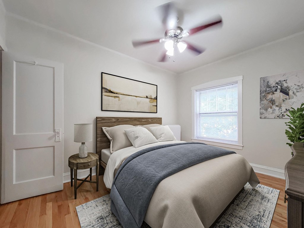 a bedroom with a bed and a ceiling fan