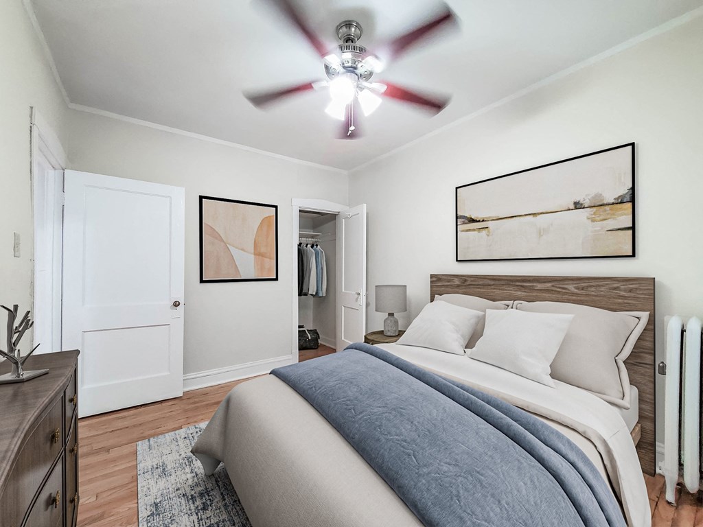 a bedroom with a bed and a ceiling fan