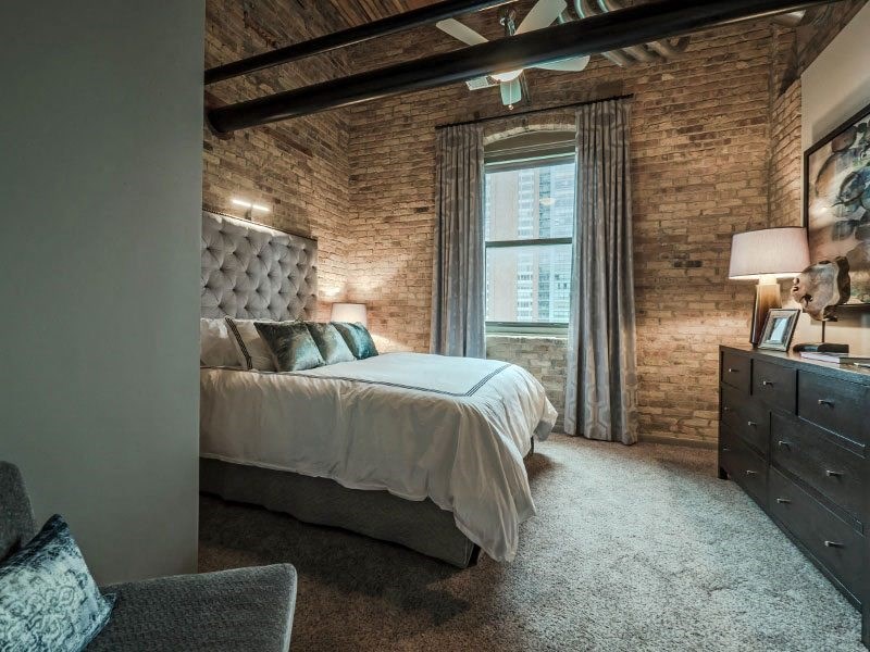 a bedroom with a bed and a dresser