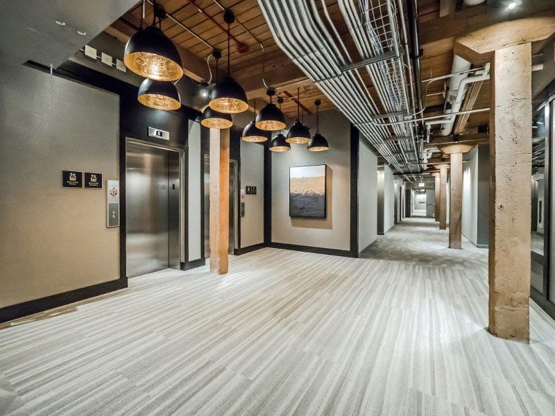 Chicago luxury apartment hallway and elevator lobby with exposed beams