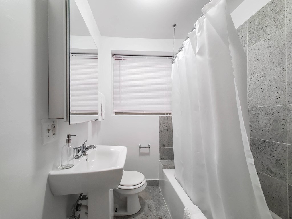 a bathroom with a sink toilet and bathtub