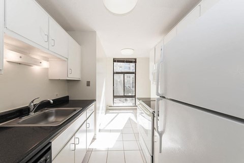 a kitchen with a sink and a refrigerator