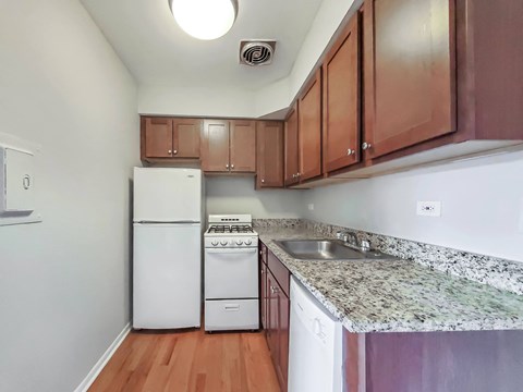 a kitchen with white appliances and granite countertops