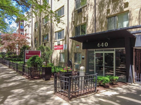 an apartment building with a large entrance and a sign that says 6410
