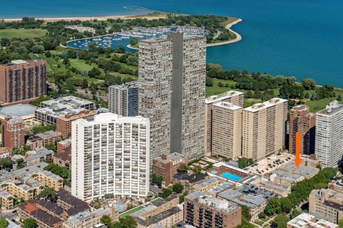 a cityscape with tall buildings and a body of water in the background