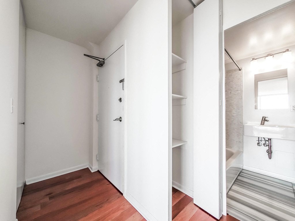 a bedroom with a medium sized bed and a mirror on the wall