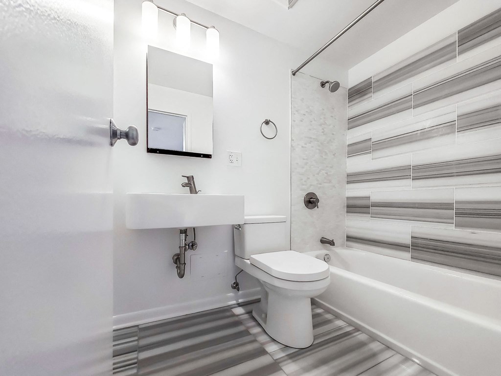 a bathroom with a sink toilet and bathtub