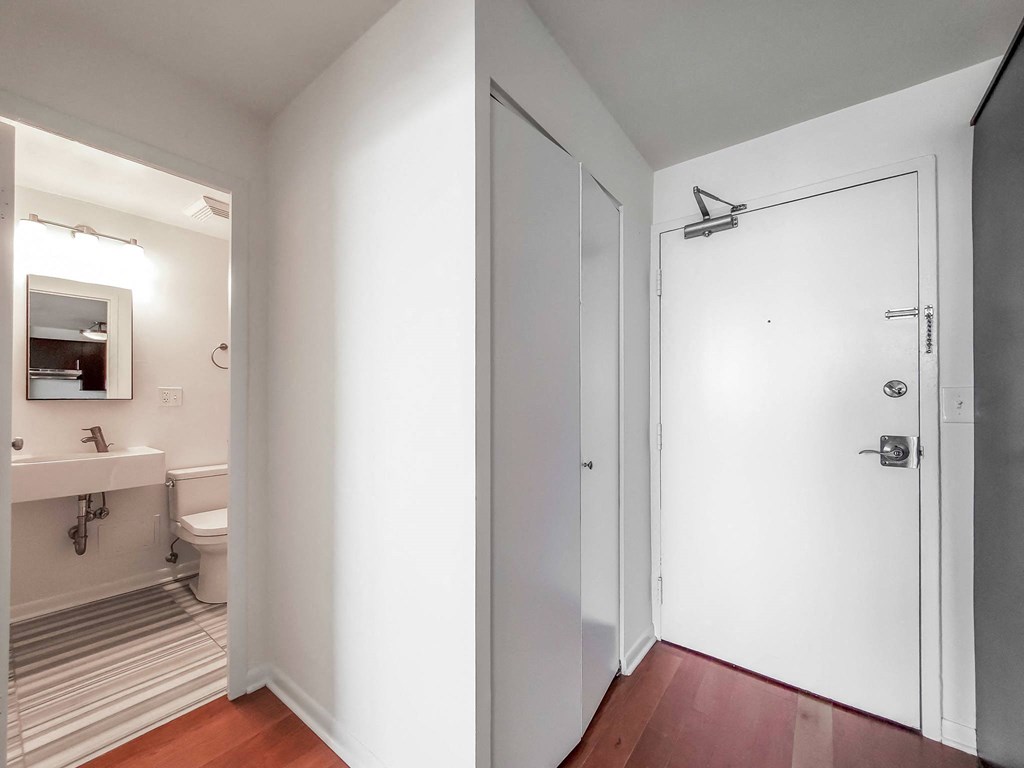 a bedroom with a medium sized bed and a mirror