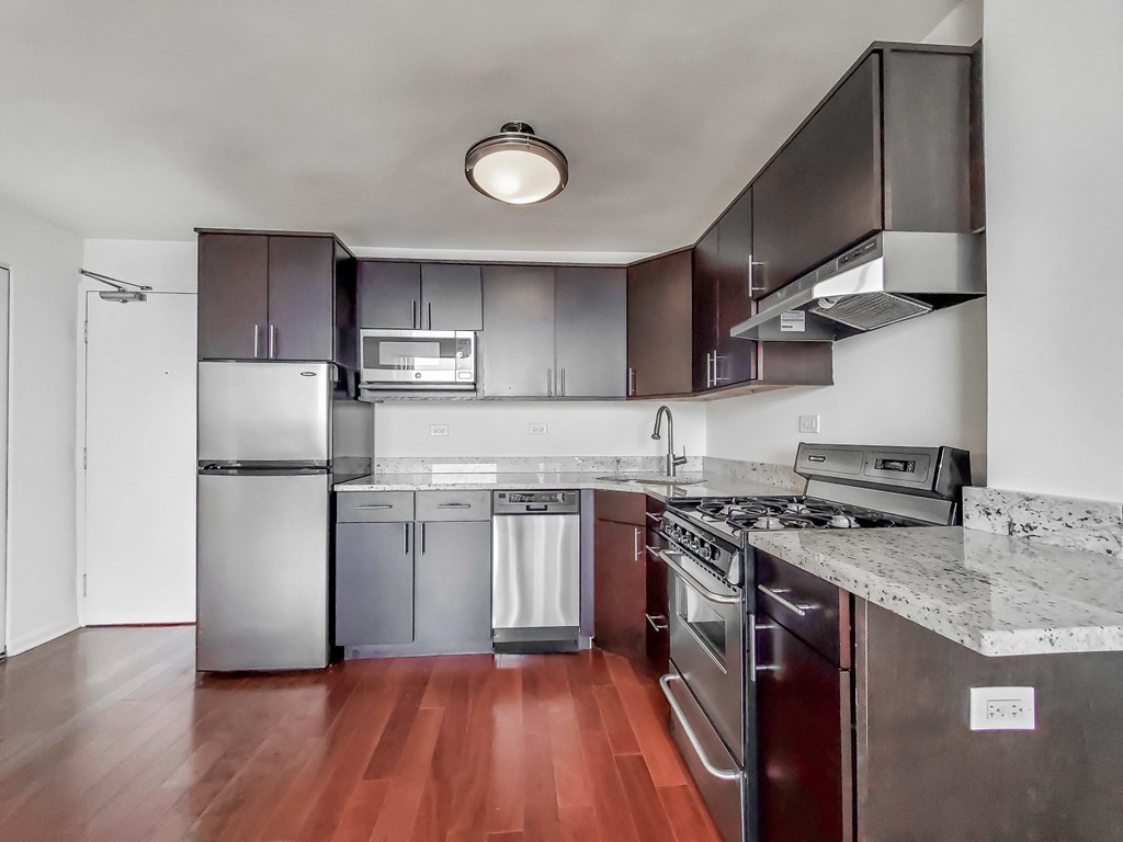 a kitchen with stainless steel appliances and granite countertops