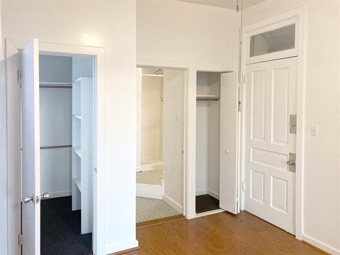 a bedroom with a closet and a door open