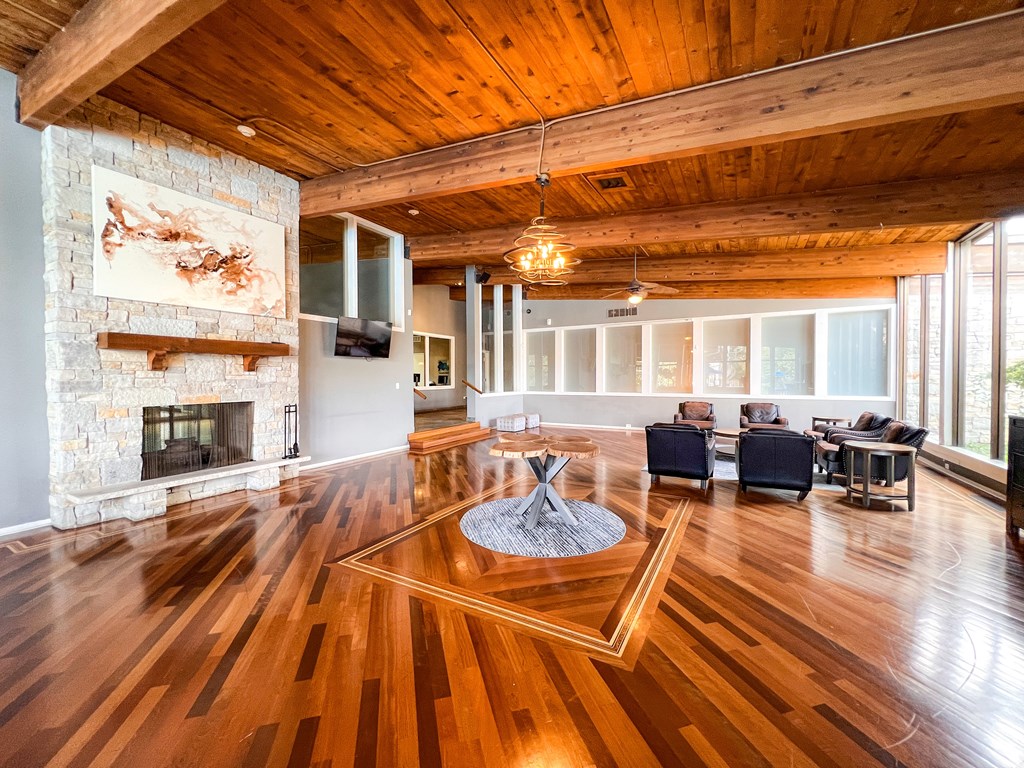 A living room with a fireplace and a painting on the wall.
