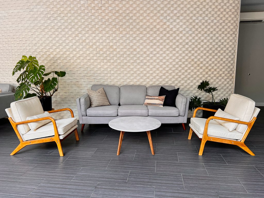 a living room with a couch and two chairs