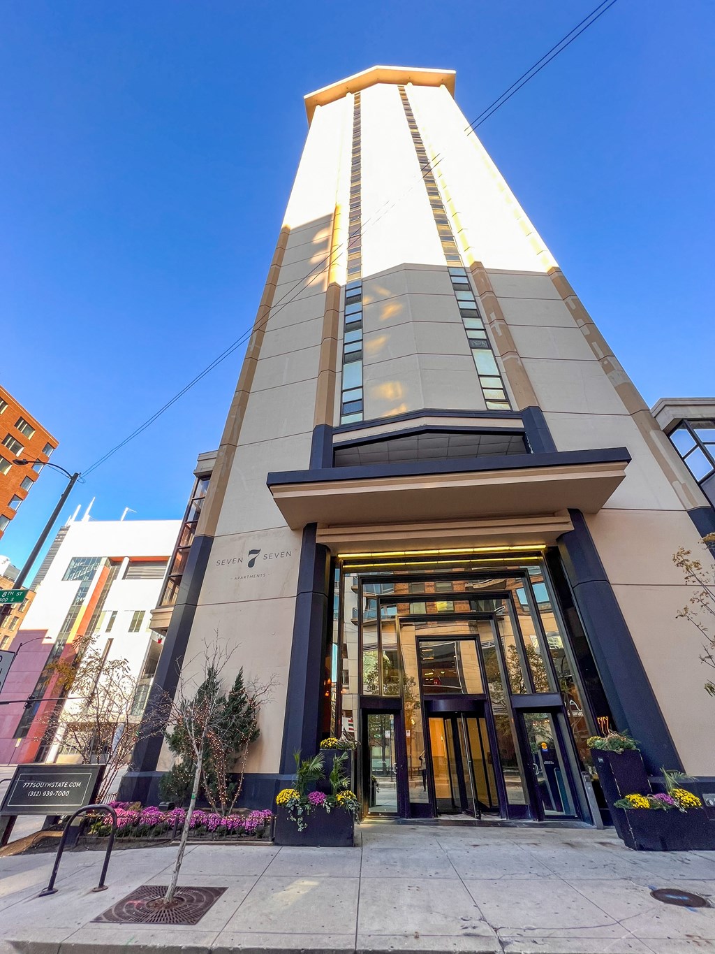 a view of the front of a tall building with a blue sky