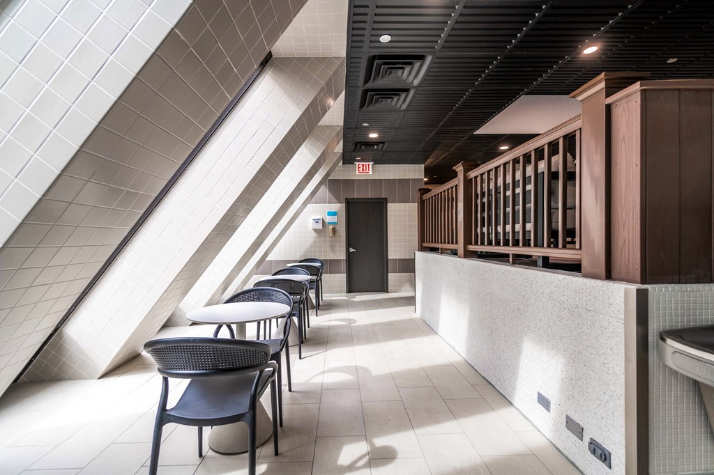 a row of tables and chairs in a corridor