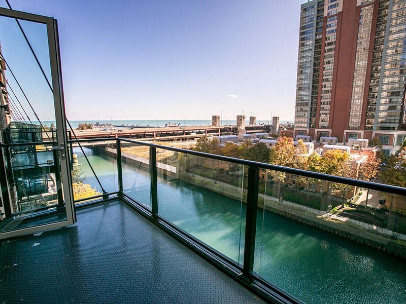 a balcony with a view of a river and a city in the background