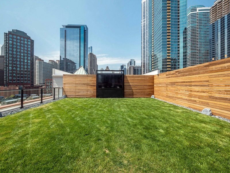 a roof top garden with a view of the city