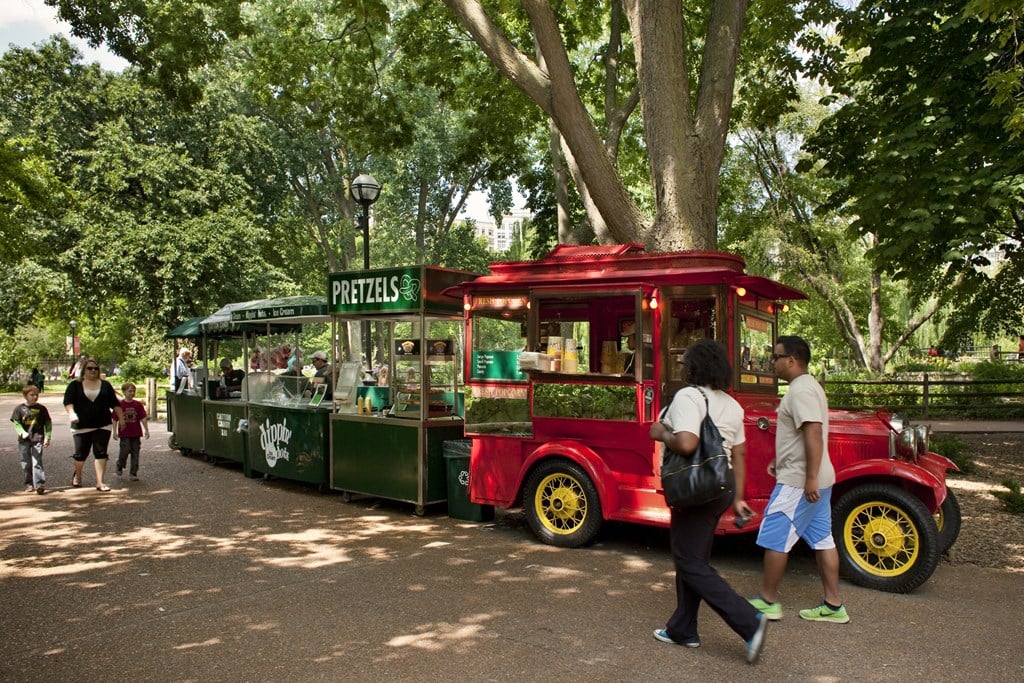 a food truck parked in front of a tree