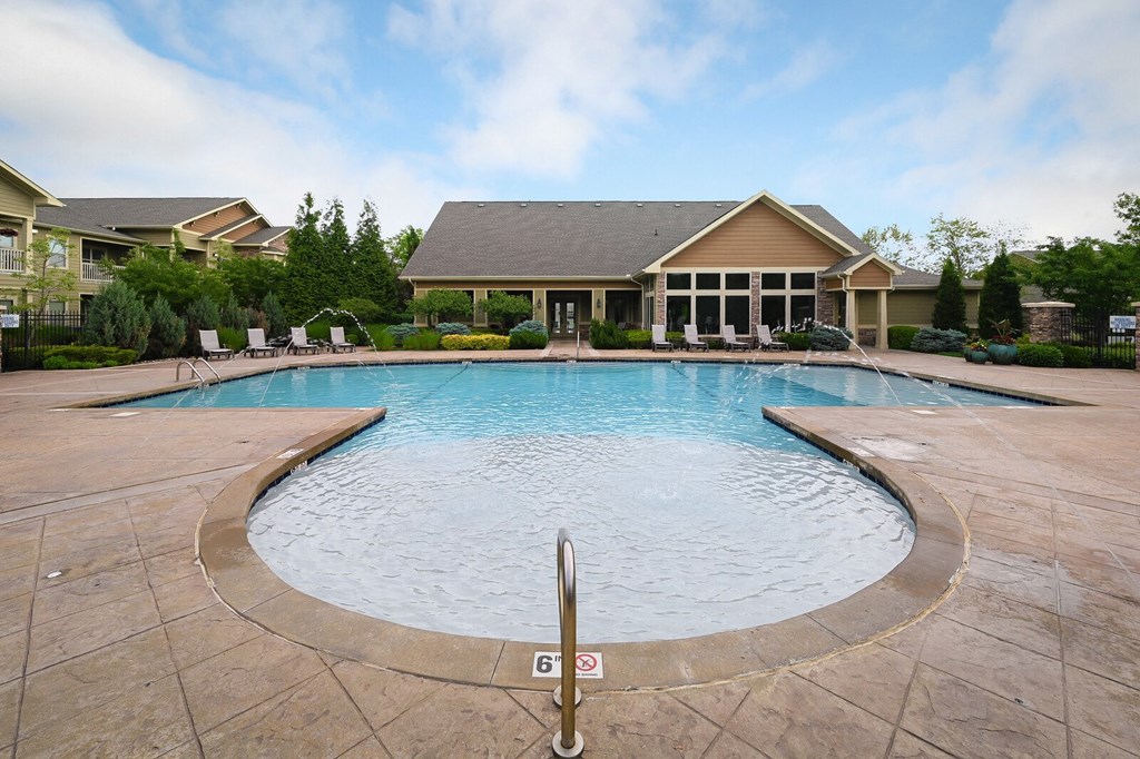a large pool with a house in the background
